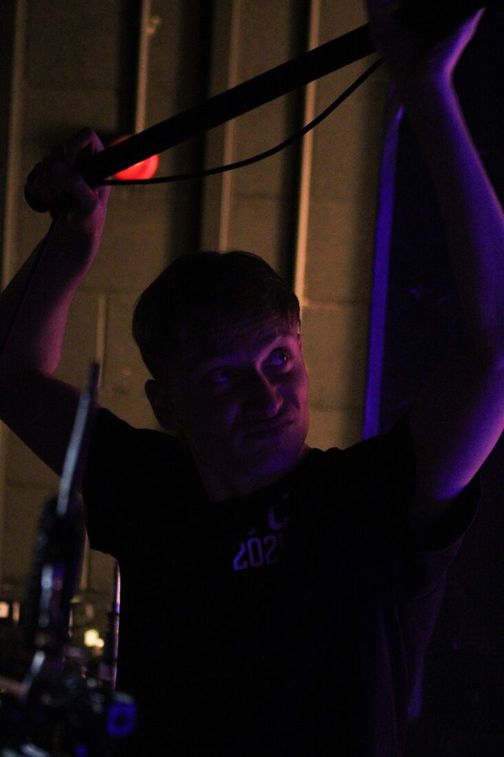 Daniel Friend boom operating under stage lighting